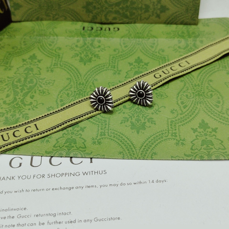 G*u*i earrings
